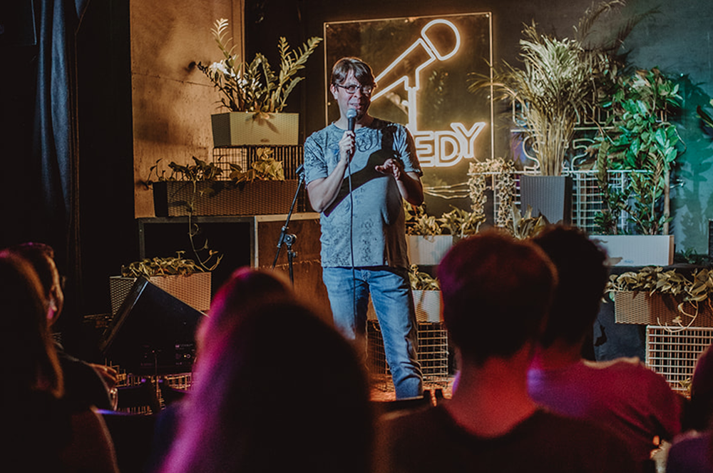 Man holding microphone at comedy club