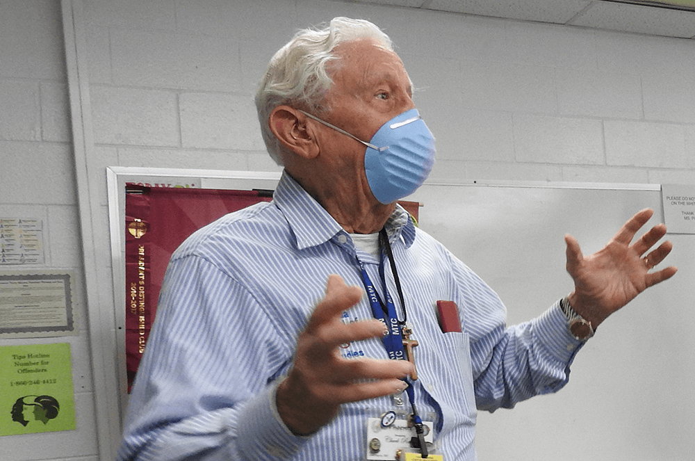 Man wearing mask gesturing with hands