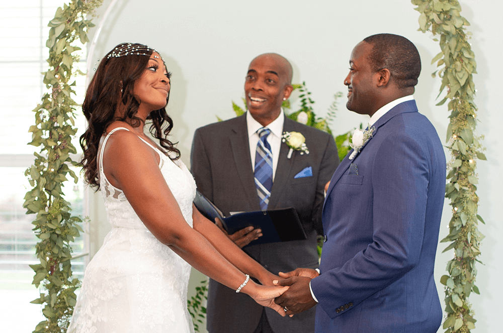 Man officiating indoor wedding ceremony