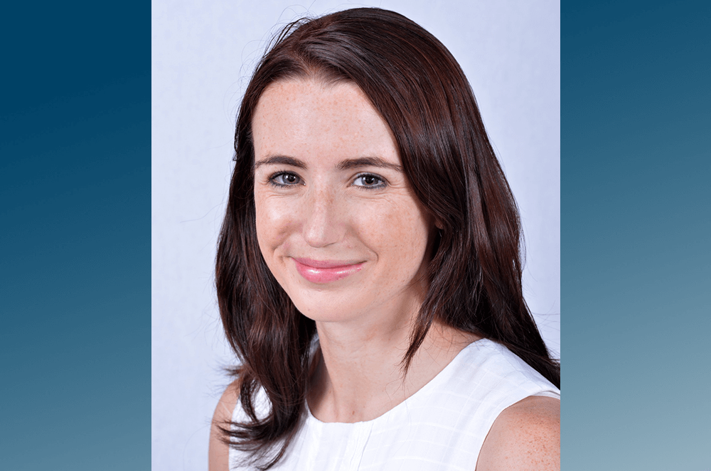 Woman in white tank top smiling