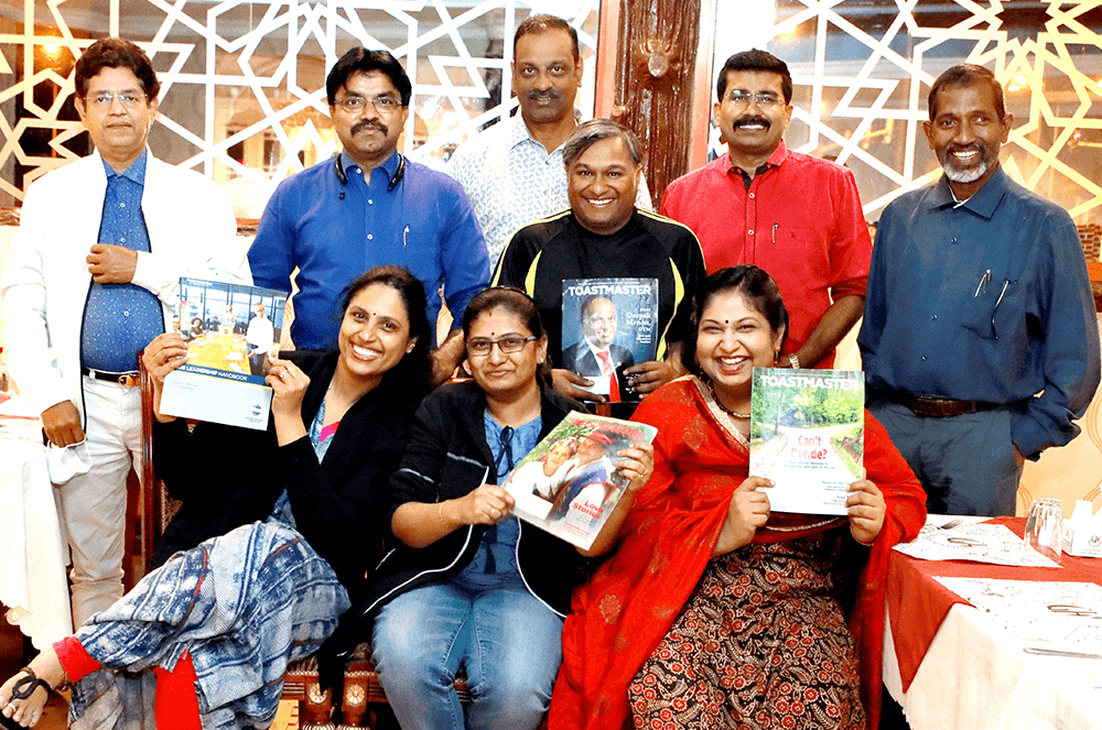 Group of people holding magazines 