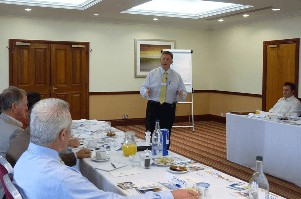 Man in yellow tie training others