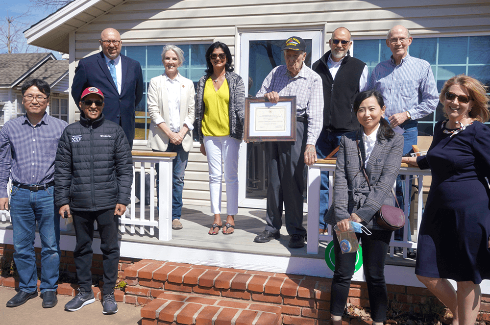 Group of people posing outside on porch