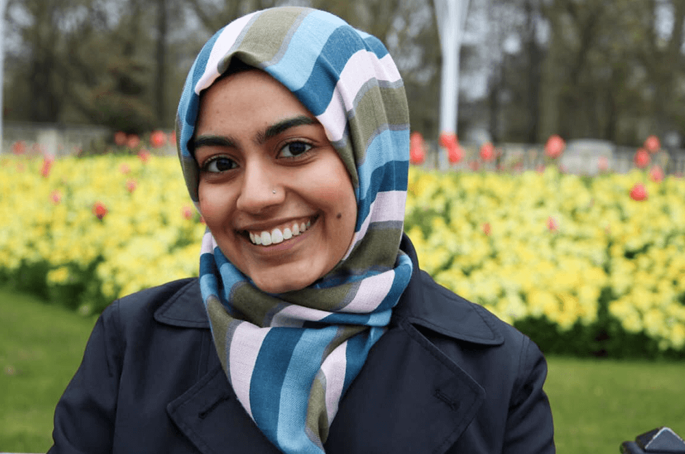 Woman smiling with flowers in background 